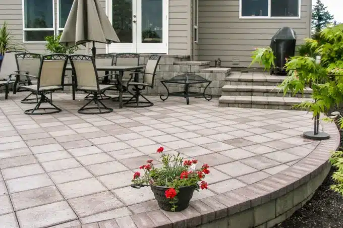 Arena Stone Pewter Patio with Chairs, Umbrella and Flowers