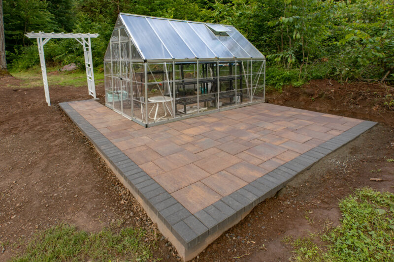 small green house on rectangular patio
